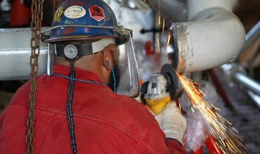 A worker using an angle grinder.